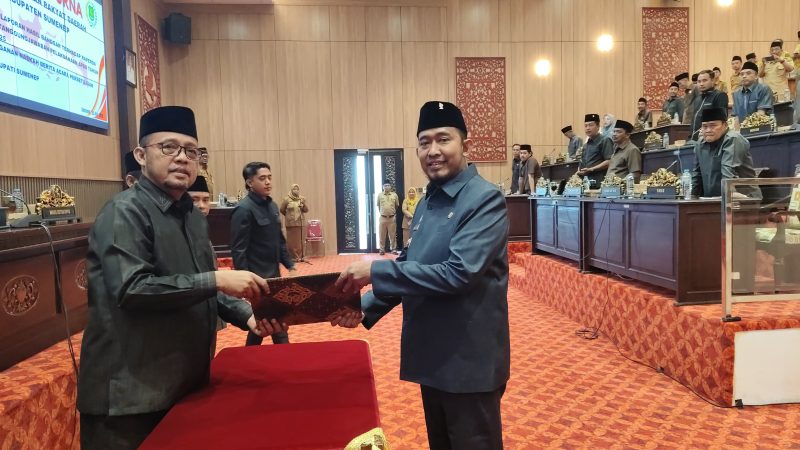 Bupati Fauzi (kanan) saat menerima salinan persetujuan raperda pertanggungjawaban APBD 2025