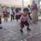 Seorang anak TK yang sedang mencoba permainan Engklek